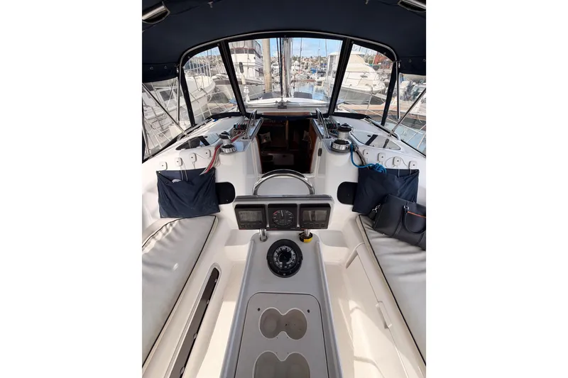 Slide: The Image of Cockpit of 1998 Hunter Legend 40.5 sailboat with navigation instruments and seating. - 26