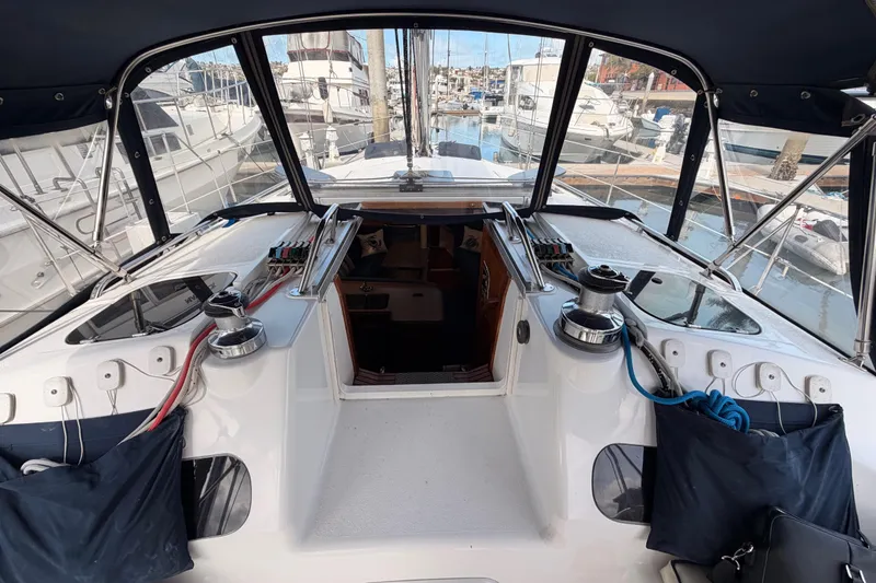Slide: The Image of Cockpit view of a 1998 Hunter Legend 40.5 sailboat docked at a marina. - 29