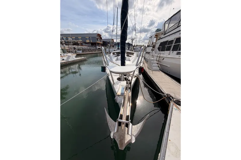 Slide: The Image of 1998 Hunter Legend 40.5 sailboat docked at marina, front view with anchor visible. - 3