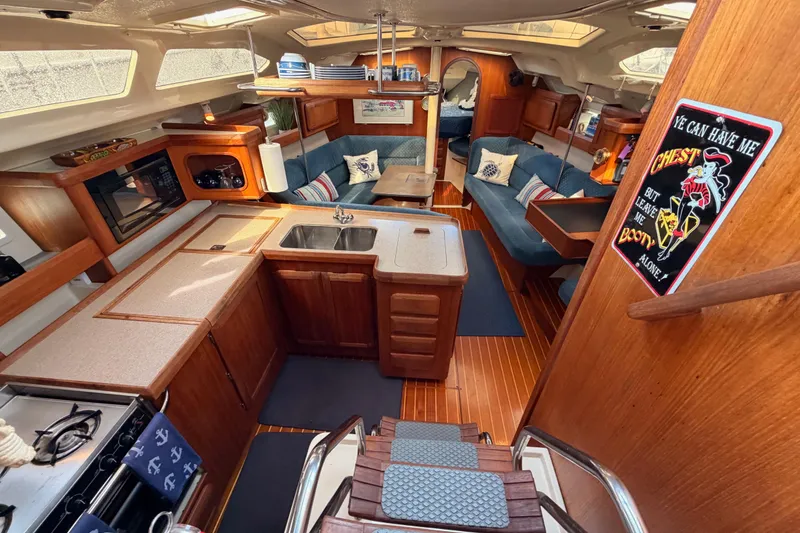 Slide: The Image of Interior of 1998 Hunter Legend 40.5 yacht with cozy seating and wooden cabinetry. - 31