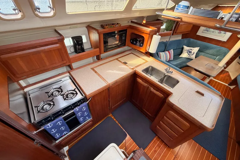 Slide: The Image of Interior of 1998 Hunter Legend 40.5 yacht with kitchen and seating area. - 33