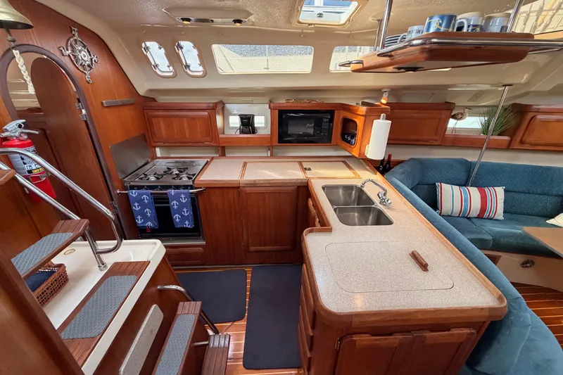 Slide: The Image of Interior of 1998 Hunter Legend 40.5 yacht with kitchen and seating area. - 35