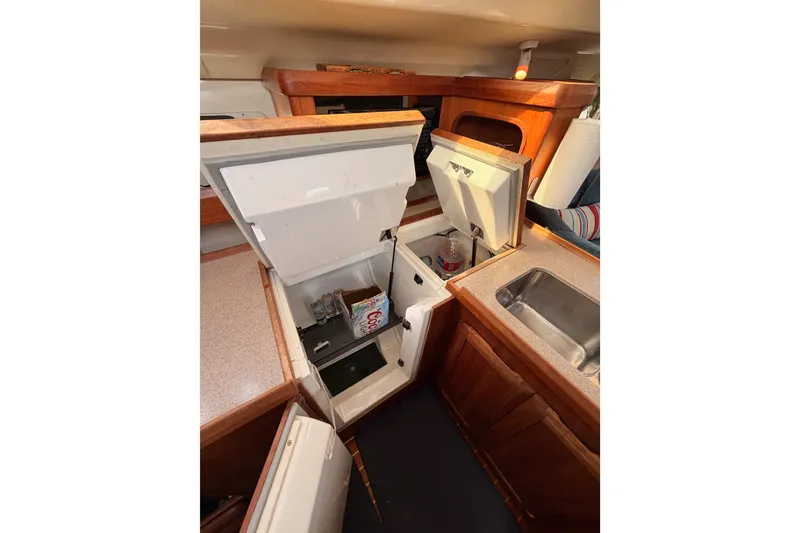 Slide: The Image of Interior of 1998 Hunter Legend 40.5 yacht kitchen with open storage compartments. - 38
