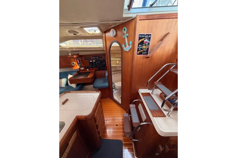 Slide: The Image of Interior of 1998 Hunter Legend 40.5 sailboat with wooden finishes and nautical decor. - 40