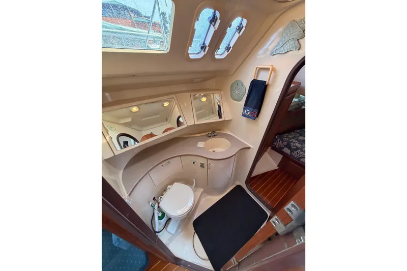 Slide: The Image of Interior of 1998 Hunter Legend 40.5 yacht bathroom with toilet, sink, and mirrors. - 41