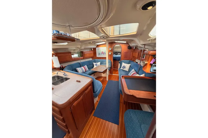 Slide: The Image of Interior of 1998 Hunter Legend 40.5 yacht with cozy seating and wooden finishes. - 44