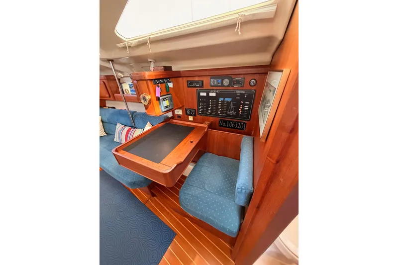 Slide: The Image of Interior of 1998 Hunter Legend 40.5 yacht with navigation station and seating. - 45