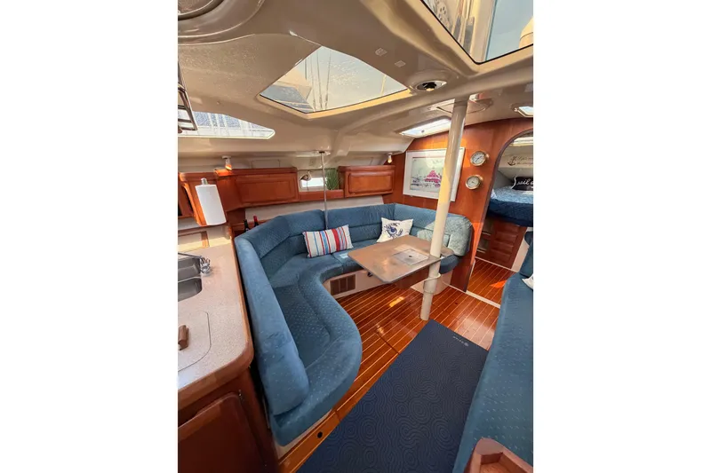 Slide: The Image of Interior of 1998 Hunter Legend 40.5 yacht with blue seating and wooden accents. - 49