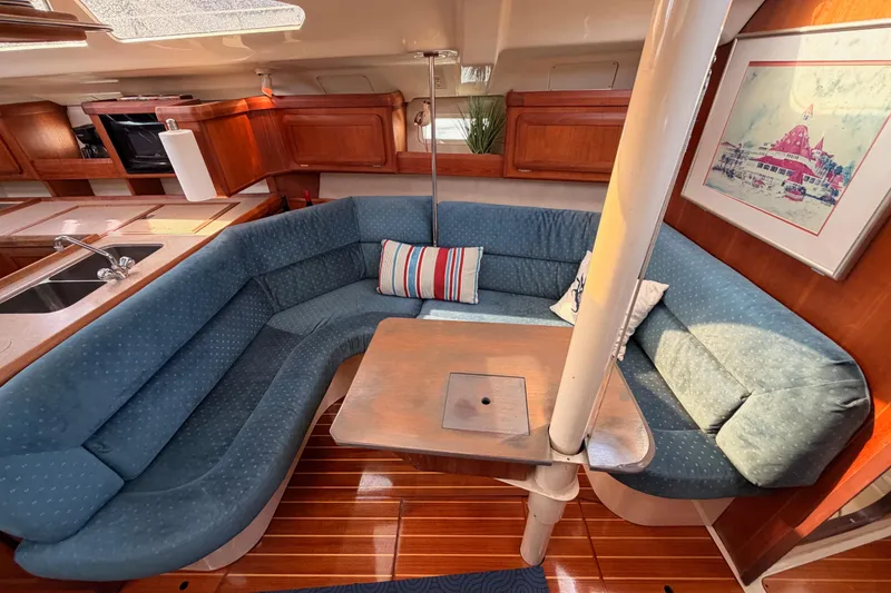 Slide: The Image of Interior of 1998 Hunter Legend 40.5 yacht with blue seating and wooden accents. - 51