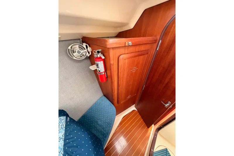 Slide: The Image of Interior of 1998 Hunter Legend 40.5 yacht with wood paneling and fire extinguisher. - 57