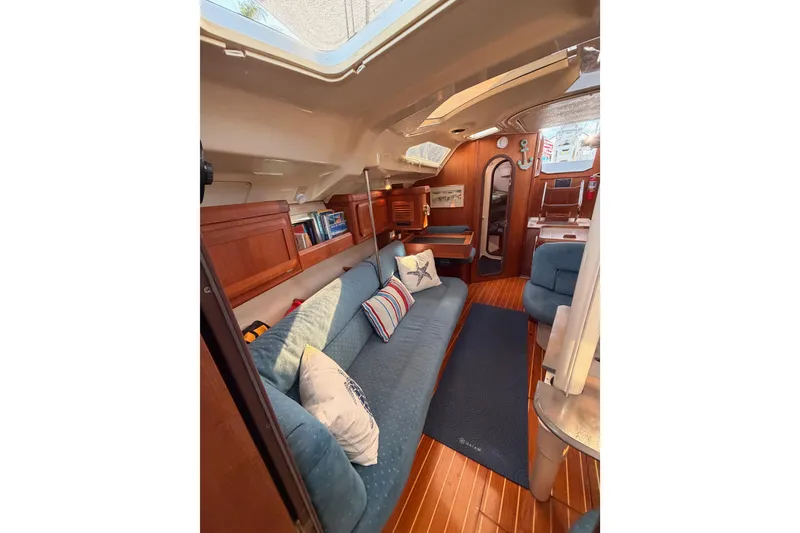 Slide: The Image of Interior of 1998 Hunter Legend 40.5 sailboat with cozy seating and wooden finishes. - 59