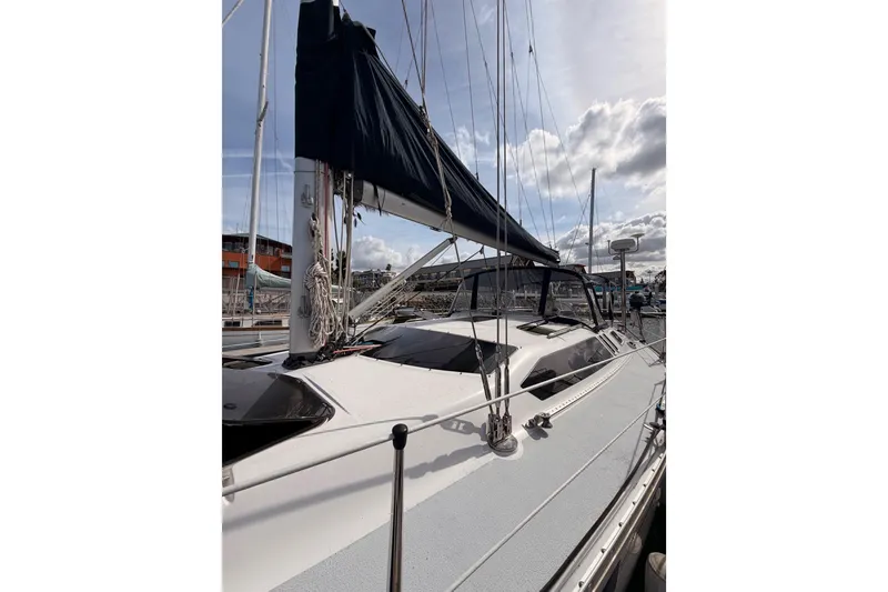 Slide: The Image of Sailboat Hunter Legend 40.5, 1998 model, docked under a cloudy sky. - 6