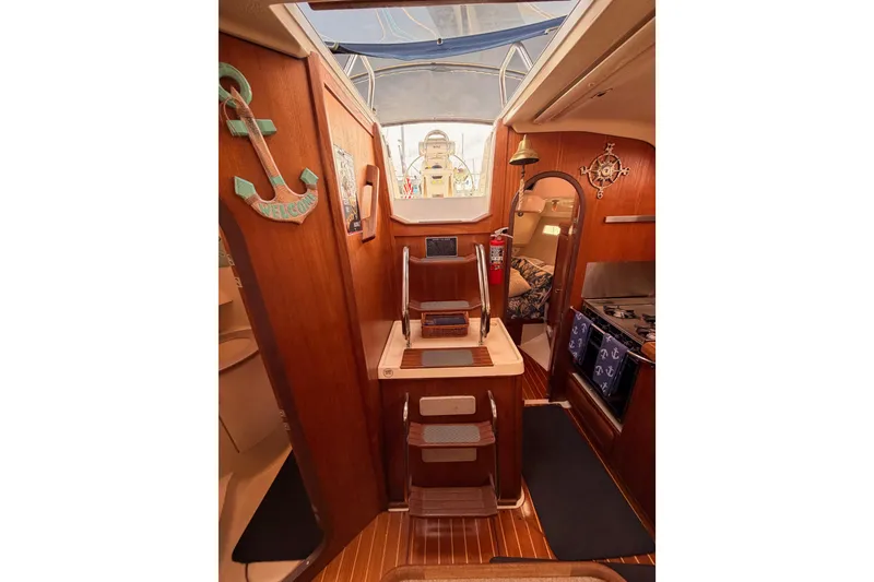 Slide: The Image of Interior of 1998 Hunter Legend 40.5 sailboat with wooden decor and nautical accents. - 62