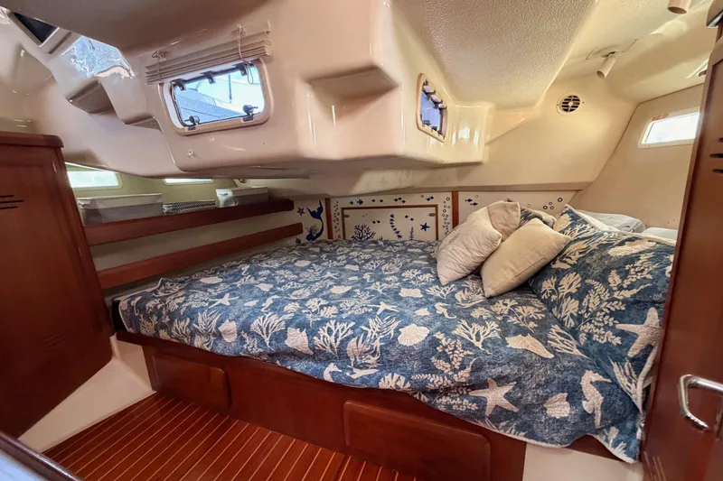 Slide: The Image of Cozy cabin interior of 1998 Hunter Legend 40.5 sailboat with nautical-themed bedding. - 64