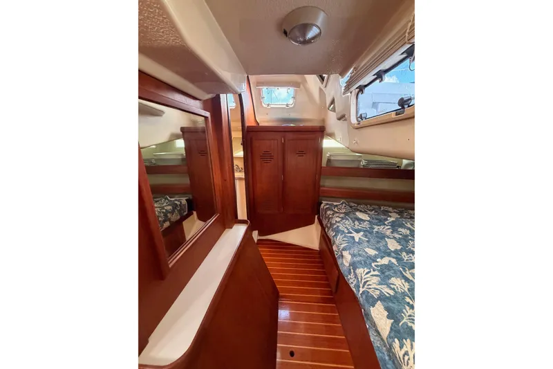 Slide: The Image of Interior of 1998 Hunter Legend 40.5 sailboat with wood finish and cozy sleeping area. - 66