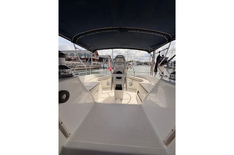 Slide: The Image of 1998 Hunter Legend 40.5 sailboat cockpit with canopy, docked at marina. - 68
