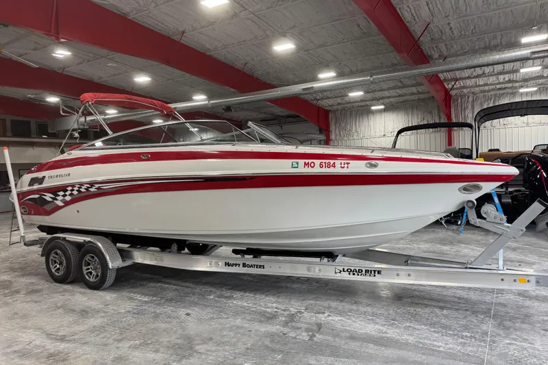 The Image of 2003 Crownline 270 BR boat on trailer in indoor storage facility. - 1