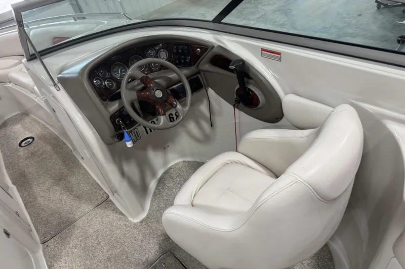 Slide: The Image of 2003 Crownline 270 BR boat cockpit with steering wheel and control panel. - 11