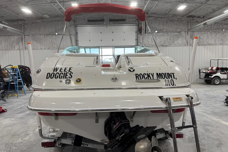 Slide: The Image of 2003 Crownline 270 BR boat in garage, labeled "Weee Doggies" and "Rocky Mount, MO." - 5