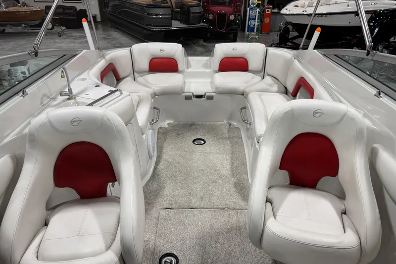 Slide: The Image of Interior of a 2003 Crownline 270 BR boat with white and red seating. - 8
