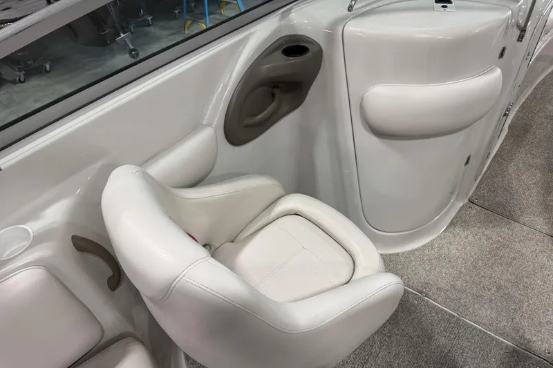Slide: The Image of 2003 Crownline 270 BR boat interior with white seating and carpeted flooring. - 9