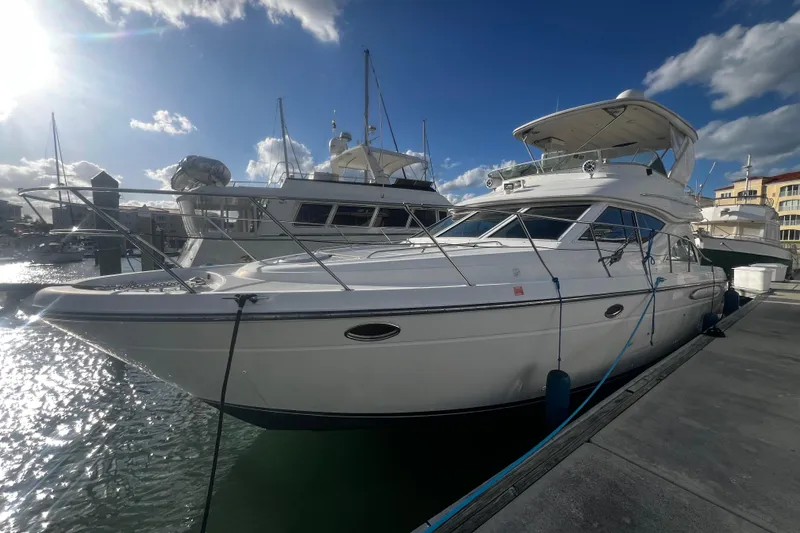 The Image of 2001 Maxum 4600 SCB Limited Edition yacht docked under a clear blue sky. - 0