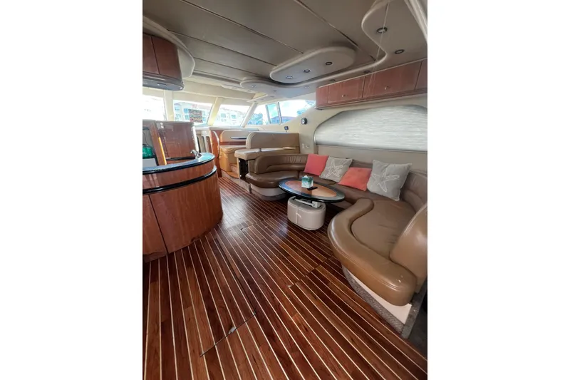 Slide: The Image of Luxurious interior of 2001 Maxum 4600 SCB yacht with elegant wood flooring and plush seating. - 15