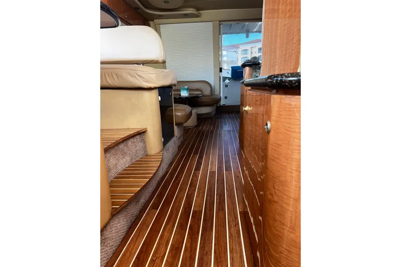 Slide: The Image of Interior of 2001 Maxum 4600 SCB yacht with polished wood flooring and luxurious seating. - 16