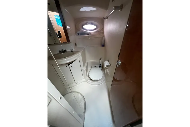 Slide: The Image of Bathroom interior of 2001 Maxum 4600 SCB Limited Edition yacht, featuring sink and toilet. - 19