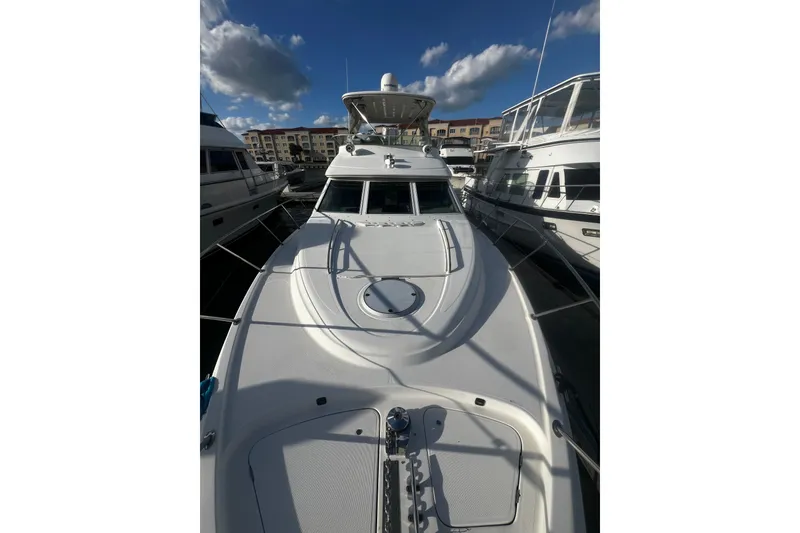 Slide: The Image of 2001 Maxum 4600 SCB Limited Edition yacht docked under a clear blue sky. - 2