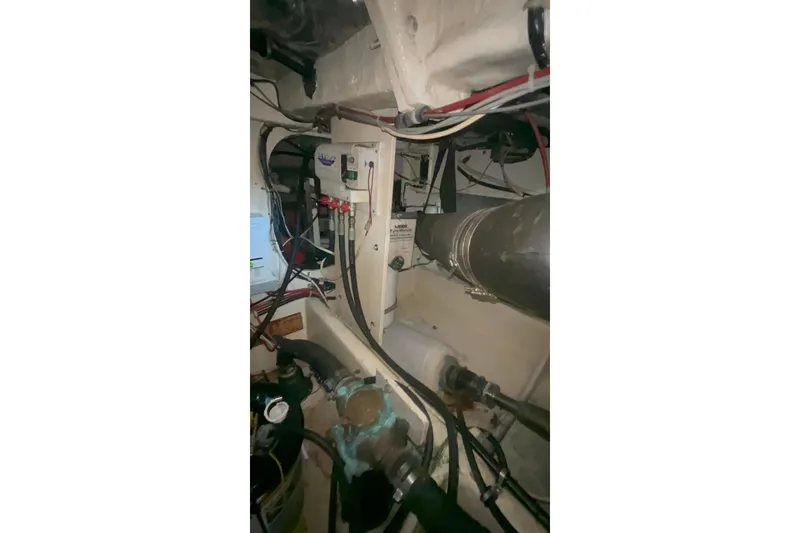 Slide: The Image of Engine room of 2001 Maxum 4600 SCB Limited Edition yacht, showcasing mechanical components and wiring. - 21