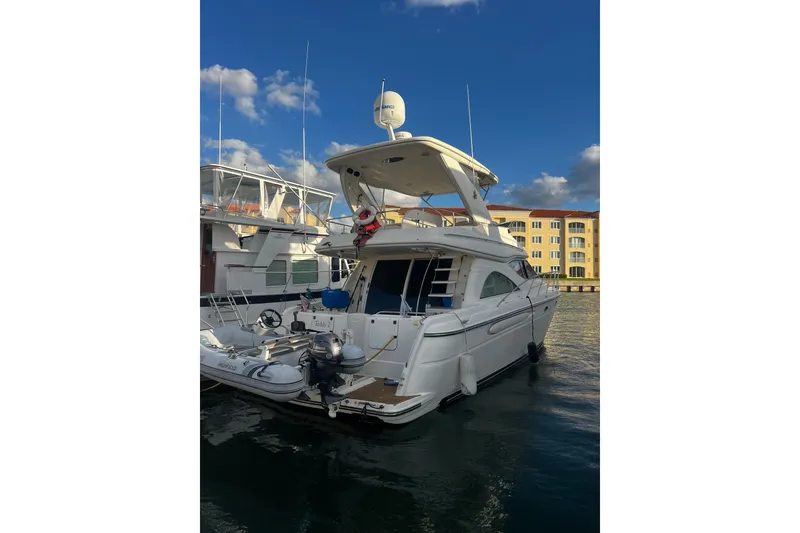 Slide: The Image of 2001 Maxum 4600 SCB Limited Edition yacht docked in marina under blue sky. - 3