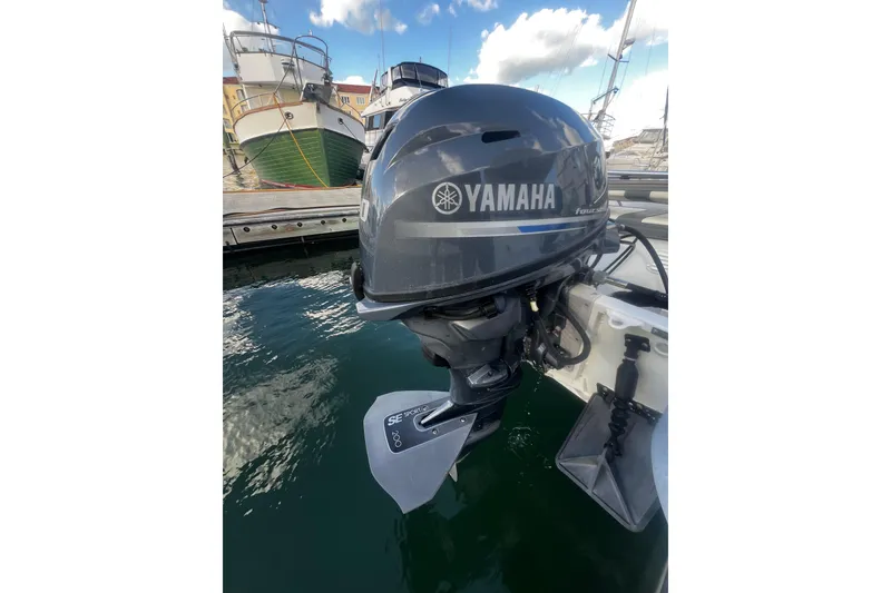 Slide: The Image of Yamaha outboard motor on a 2001 Maxum 4600 SCB Limited Edition boat at a marina. - 6