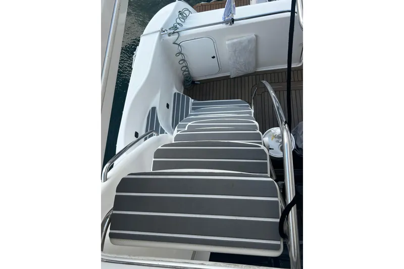 Slide: The Image of Staircase on 2001 Maxum 4600 SCB Limited Edition yacht with striped steps and railing. - 9