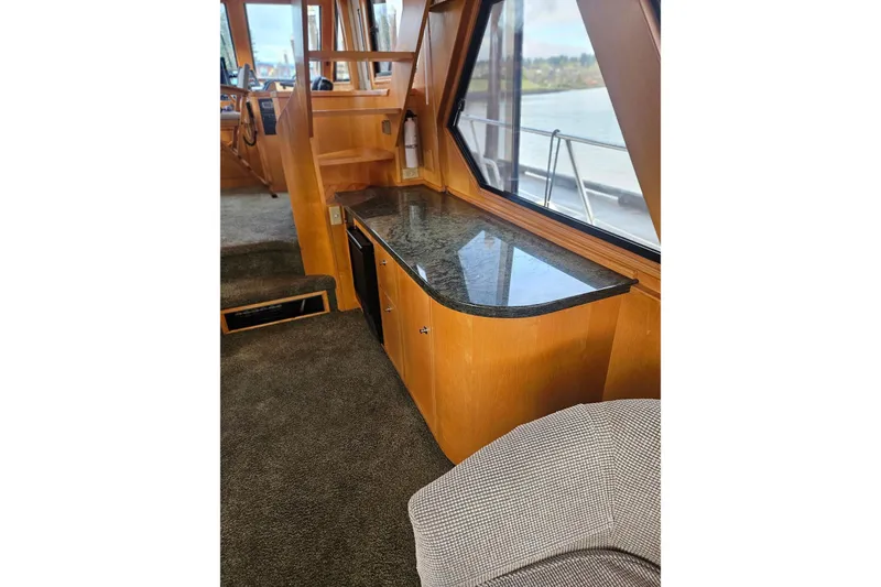 Slide: The Image of Luxurious yacht interior with granite countertop, wood cabinetry, and large windows, Symbol 55, 1995 model. - 11