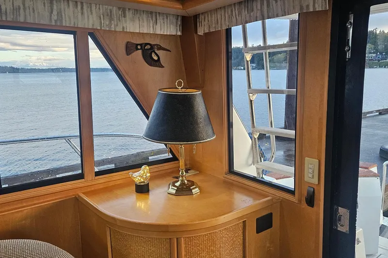 Slide: The Image of Cozy yacht interior with lamp, decorative bird, and scenic water view. Symbol 55, 1995 model. - 13