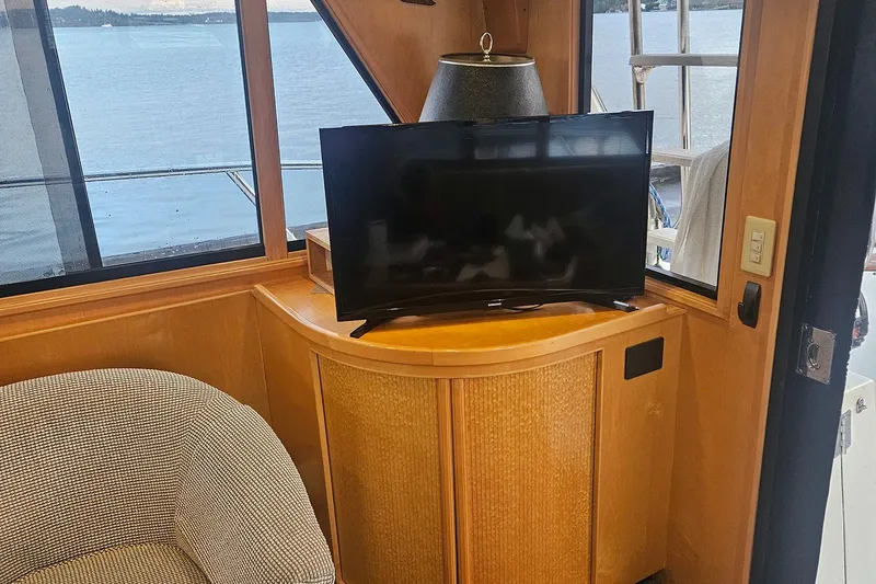 Slide: The Image of Interior of a 1995 Symbol 55 yacht with TV and scenic window view. - 14