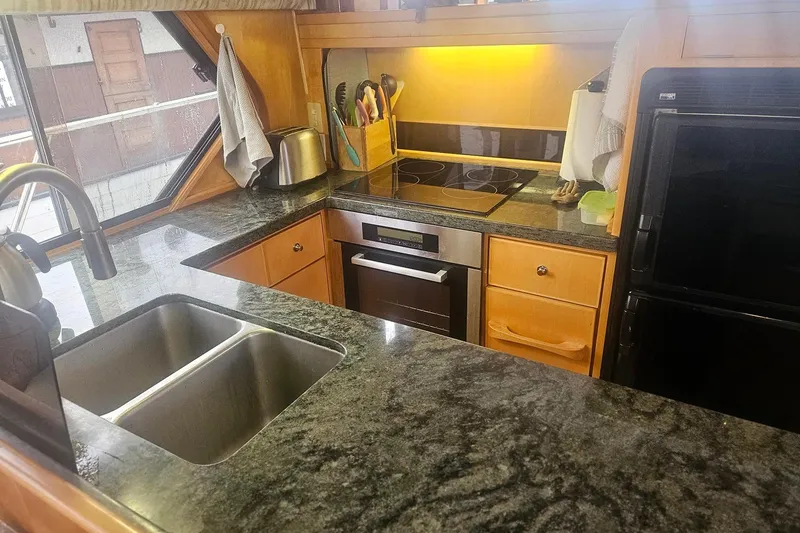 Slide: The Image of Modern kitchen in a 1995 Symbol 55 yacht with granite countertops and stainless steel appliances. - 16