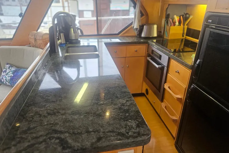 Slide: The Image of Luxurious yacht kitchen with granite countertops, modern appliances, and wooden cabinetry, Symbol 55, 1995. - 18