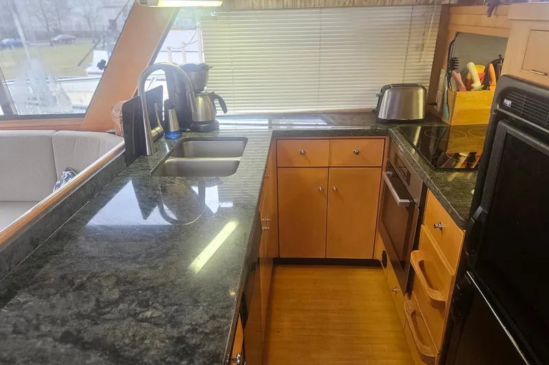 Slide: The Image of Modern yacht kitchen with granite countertops, stainless steel sink, and appliances, Symbol 55, 1995 model. - 19