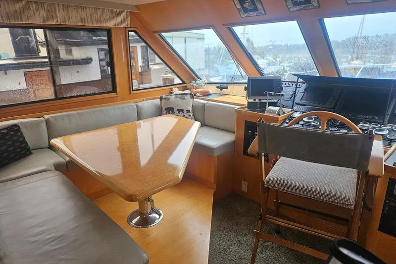 Slide: The Image of Luxurious yacht interior with helm, seating, and wooden table, Symbol 55, 1995 model. - 20