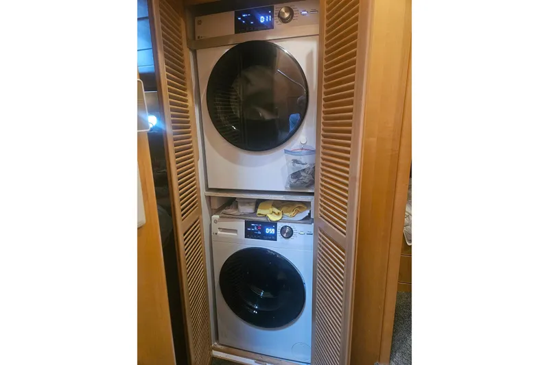 Slide: The Image of Stacked washer and dryer in a wooden closet, Symbol 55 model, 1995. - 23