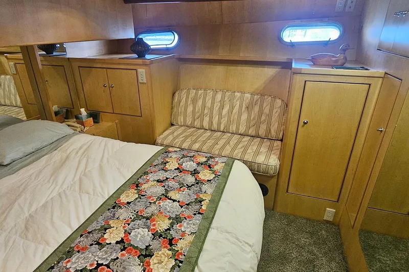 Slide: The Image of Cozy bedroom in 1995 Symbol 55 yacht with floral bedspread and wooden cabinetry. - 30