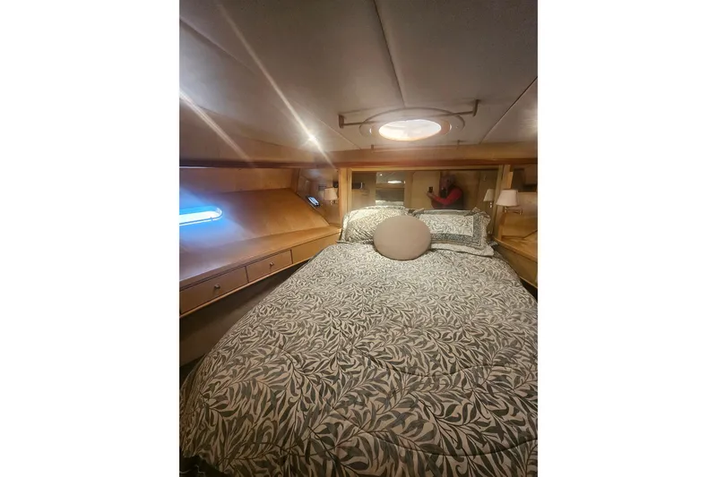 Slide: The Image of Cozy cabin interior of a 1995 Symbol 55 yacht with patterned bedding. - 32