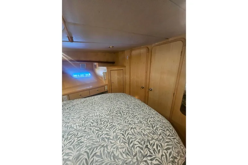 Slide: The Image of Cozy bedroom interior in 1995 Symbol 55 yacht with wood paneling and patterned bedding. - 36