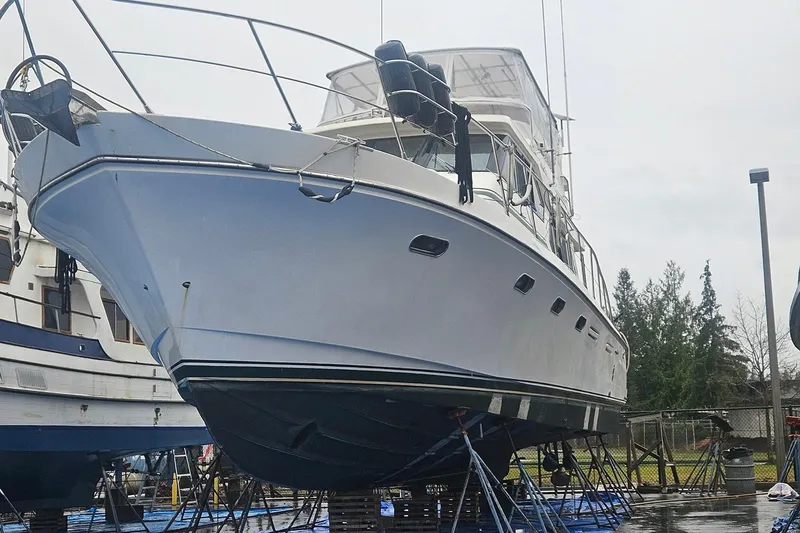 Slide: The Image of A 1995 Symbol 55 yacht on dry dock, showcasing its sleek design and sturdy hull. - 4