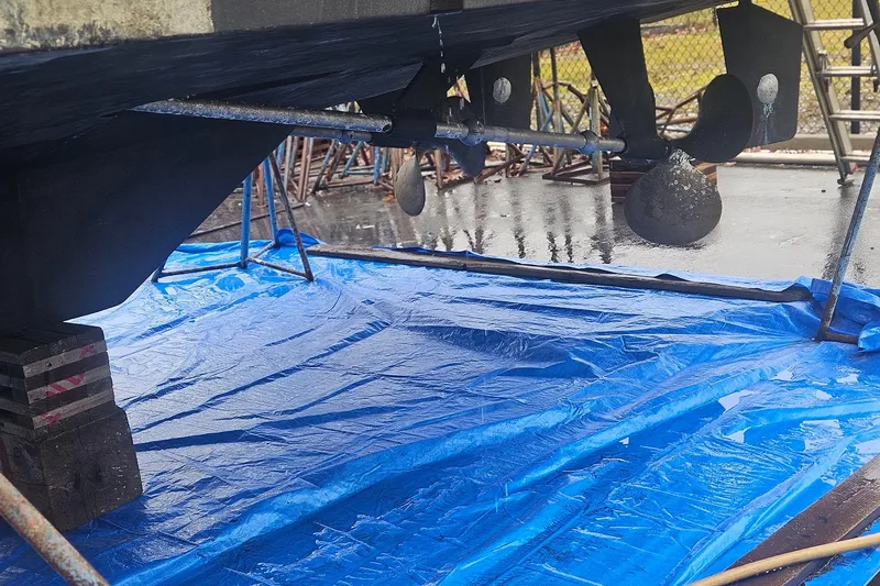Slide: The Image of Boat hull maintenance with tarp, showing propeller and rudder, Symbol 55, 1995 model. - 6