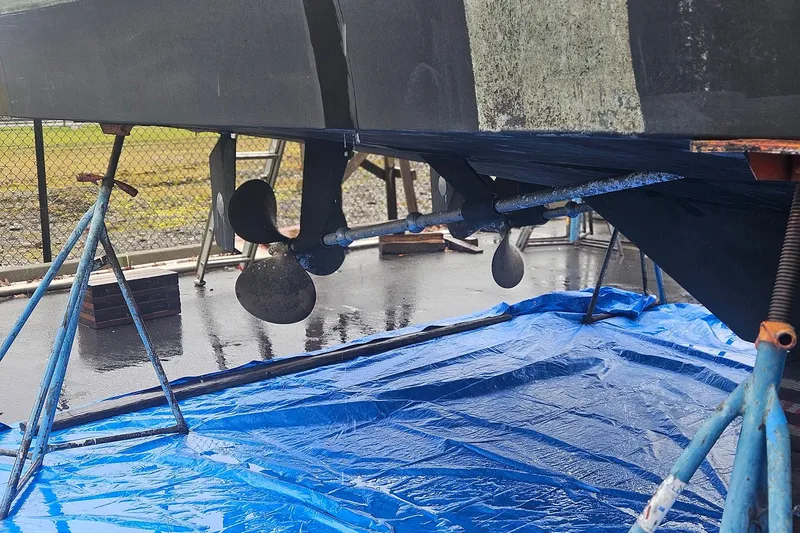 Slide: The Image of Boat propeller and rudder of a 1995 Symbol 55 on a blue tarp. - 7