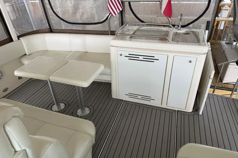 Slide: The Image of 2003 Cruisers Yachts 405 Express Motoryacht interior with seating, tables, and kitchenette. - 12