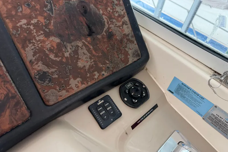 Slide: The Image of Control panel of a 2003 Cruisers Yachts 405 Express Motoryacht with weathered dashboard. - 16